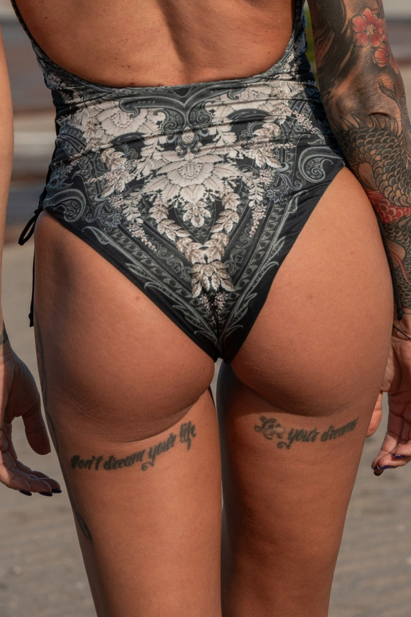 ONE-PIECE SWIMSUIT WITH ZIP AND SIDE TIES – FROZEN LOTUS